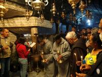 Christian worshippers and clerics pray inside the Grotto, believed to be the exact spot where Jesus Christ was born, at the Church of the Nativity in the biblical West Bank city of Bethlehem, on December 22, 2018, three days ahead of the Christmas celebration. Musa Al Shaer/AFP
