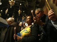 Christian worshippers pray inside the Grotto on December 22, 2018, three days ahead of the Christmas celebration. Musa Al Shaer/AFP 
