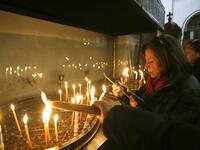 Christian worshipers light candles at the Church of the Nativity in the biblical West Bank city of Bethlehem, on December 22, 2018, three days ahead of the Christmas celebration. Musa Al Shaer/AFP 