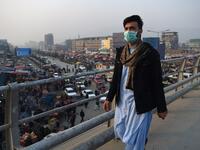 In this photograph an Afghan resident wearing a face mask walks along an overpass amid heavy smog conditions in Afghanistan's capital Kabul. 
WAKIL KOHSAR / AFP
