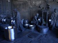 In this photo  Afghan labourers polish metal pots at an aluminum factory in Herat. 
HOSHANG HASHIMI / AFP