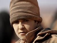A young boy covered in dust is ppictured as people who fled battles between Syrian Democratic Forces (SDF) and ISIS fighters in the Syrian village of Baghouz, arrive after crossing a desert in the back of a truck to a region controlled by the SFD in the countryside of the Deir Ezzor province  Delil SOULEIMAN / AFP