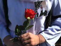 An Iraqi Yazidi carries a rose during the funeral of the Mir Takhsin-Beg (Tahseen Said Ali), the hereditary leader of the Yazidi community in the world, in the town of Sheikhan, 50km northeast of Mosul. 
SAFIN HAMED / AFP