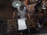 Pakistani workers dye fabric threads at a factory in Lahore 
ARIF ALI / AFP