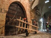 Labourers take part in restoration work at the Saqatiya market in the old quarter of Syria's second city of Aleppo 
LOUAI BESHARA / AFP