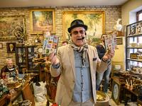 Auctioneer Ali Tuna shows items to the audience at an auction house in Istanbul's Balat.
OZAN KOSE / AFP