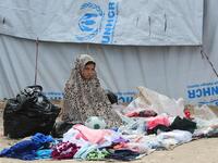 A displaced girls sells second hand items  in the souk or market of Al-Hol camp for displaced people in northeastern Syria 
GIUSEPPE CACACE / AFP