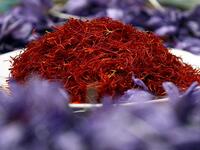 Afghan worker spreads separated saffron threads from harvested flowers at a processing centre in Herat province (Twitter)