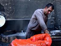Afghan labourers work at a traditional sweet factory in Herat.
(AFP)