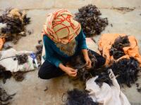 An Afghan woman works in a traditional wool factory in Herat (Twitter)