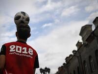 A man juggles a football in the street in Ekaterinburg on June 16, 2018, during the Russia 2018 World Cup football tournament. 
Anne-Christine POUJOULAT / AFP