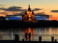 Young women stand in front of the Nizhny Novgorod stadium situated behind the cathedral of Alexandr Nevskiy in the city of Nizhny Novgorod, during the Russia 2018 World Cup on June 16, 2018. 
Johannes EISELE / AFP