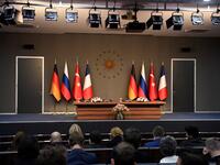 People sit in front of an empty stage ahead of a meeting during the "Four-way Istanbul summit on Syria", at Vahdettin Mansion in Istanbul, on October 27, 2018. (Bertrand GUAY / AFP)
