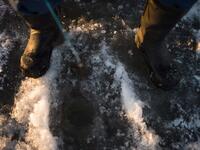 A man is ice-fishing at midday on the frozen Bothnia Sea, on December 28, 2016 in Vaasa, Western Finland. (OLIVIER MORIN/AFP)