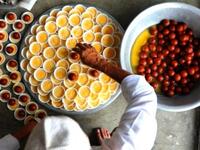 Nepal: Nepalese Muslim men prepare food to break the fast after the Jummat-Ul-Vida, the last Friday prayers, ahead of the Eid al-Fitr festival at the Kashmiri Mosque in Kathmandu. Sweets are often a center-piece in this three-day festival of a little decadence after a month of fasting. 