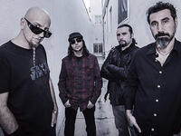 a
System of a Down also features songwriter-drummer John Dolmayan, also born in Beirut in 1973. During the Lebanese Civil War, a stray bullet hit his boyhood (and thankfully unoccupied) Beirut bed, prompting his family to emigrate and eventually landing in California, where Dolmayan would meet future bandmate Tankian.