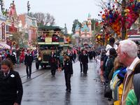People gather to watch Disneyland characters in fairy vehicles. (popsugar.com)