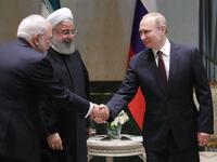 Russian President Vladimir Putin (R) shakes hands with Iranian Foreign Minister Mohammad Javad Zarif during a meeting with Iranian President Hassan Rouhani in Ankara on April 04, 2018. 
(Mikhail KLIMENTYEV /Sputnik/AFP)
