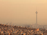 Residential buildings in front of Milad Tower in air-polluted skyline of Tehran illuminated with golden sunset, 435 meters (Shutterstock/File Photo)