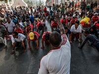 People take part in an exercise on a street in Addis Ababa on February 3, 2019 during the third Car Free Day promoted by local NGOs and the Ethiopian Government to appeal to a healthy life style and a less air pollution of the capital city. 
EDUARDO SOTERAS / AFP