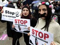 Lebanese women hold placards as they participate in a march against marriage before the age of 18, in the capital Beirut on March 2, 2019. 
ANWAR AMRO / AFP