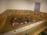 Men sit together in a pool of water at the first traditional Turkish bath (Hammam) opening in the occupied Palestinian West Bank city of Hebron on March 11, 2019. 
HAZEM BADER / AFP