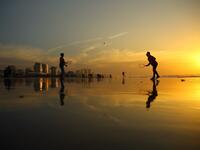 Palestinians play tennis on the beach during the sunset in Gaza City on January 11, 2017. (AFP/MOHAMMED ABED)
