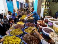 Libyans shop for olives and pickles at a market in the centre of the capital Tripoli, as the faithful prepared for the start of the Muslim holy month of Ramadan. 
AFP/MAHMUD TURKIA
