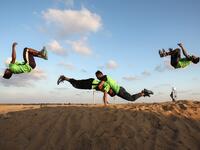 In the same tent site, east of Rafah in the southern Gaza Strip, Palestinian youths practice their parkour skills. Photo taken on April 10, 2018. SAID KHATIB / AFP