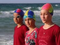 Young Palestinian members of a swimming club, prepare to swim during training session. (SAID KHATIB / AFP)