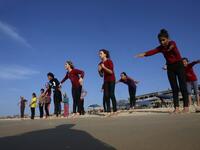 Young Palestinian members of a swimming club, participate in a group excercise on the beach during a training session in Beit Lahia in the northern Gaza Strip. (SAID KHATIB / AFP)