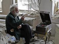 “Anis puffed on his pipe,” the AFP’s Joseph Eid wrote. “He looked out the window and he had a look on his face of a person watching a beautiful sunset. He sat there, puffing on his broken pipe and staring out the window as the music floated over the ruins of his house and the city outside.”  