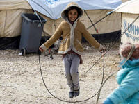 A displaced Syrian child fleeing from Deir Ezzor city besieged by Daesh plays with a skipping rope. As a result of the Syrian crisis, some 2.5 million are living as refugee children in neighbouring countries. These children have lost their homes, schools and communities but do not give up on finding happiness in the small things that remain.