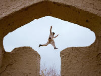 An Afghan boy plays in the ruins of a house that at one point belonged to the 13th-century Perisan poet, Jalal ad-Din Muhammad Rumi, on the outskirts of Mazar-i-Sharif. 