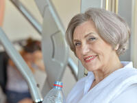 older woman exercising at gym