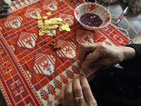 This 48-year-old Palestinian woman supports her family through home-based embroidery business while keeping the tradition alive. "By doing this work, which is part of our Palestinian heritage, I feel that women can renew our heritage and save it from extinction." (AFP)