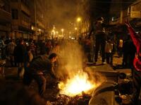 Egyptian Christians burn trash containers during a protest late near the Al-Qiddissine church.