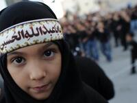 Ashura derives from 'tenth': It is a holy day for Islam marked on the 10th of 'Muharram', the first month of the Islamic lunar 
calendar. Muharram represents a period of mourning for a historical grievance in Shia Islam,
culminating Ashura. This child displays a classic lament for the revered martyr: 'O Hussein you were the father of Abdullah'.