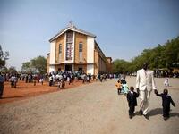 South Sudanese gather following the Christmas service at the Juba Catholic Cathedral, in the southern Sudan's capital city.