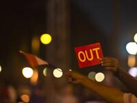 An Egyptian man holds up a red card against the country's Islamist President in front of the presidential palace in Cairo (AFP)