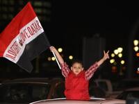 Egyptian boy bears the note of endearment: "love Egypt, love Qatar"  during celebrations by his community of Mubarak's downfall.
