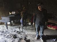 Israeli Nissan Cohen, 84, inspects his burnt Nisco Museum of Music boxes and Mechanical Music, in the artists village of Ein Hod near the northern city of Haifa, after a massive forest fire was finally brought under control, with the assistance of equipment and personnel from more than 16 countries.

