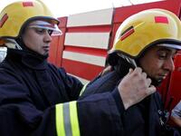 Palestinian firefighters get ready to cross the Israeli-controlled Jalama checkpoint near the West Bank city of Jenin, as they head to the Israeli city of Haifa to join the battle against a blazing Israeli forest.