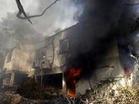 An Israeli firefighter prepares to douse a burning house in the Artists; village of Ein Hod near the northern city of Haifa.