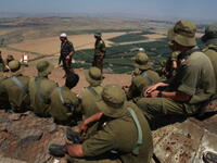 Israeli soldiers in the Golan face Syria 