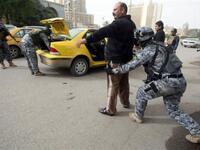 Iraqi troops implement strict security measures on main roads in Baghdad,as Shiite Muslims prepare to mark the religious event of Ashura on December 17 at the end of ten days of mourning for in commemoration of the 7th century killing of Imam Hussein.