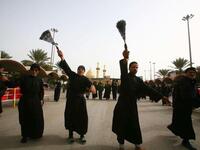 Shiite Muslim men flagellate themselves with chains in an Ashura ritual in the shrine city of Karbala in central Iraq, as believers prepare to mark the religious event of Ashura on December 17 in commemoration of ten days of mourning for Imam Hussein.