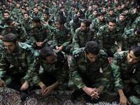 Iranian soldiers sit during the ceremony.