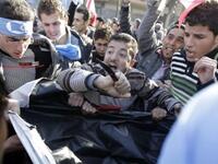 Supporters of the Future Movement rip a poster of Lebanese MP Najib Mikati during a demonstration in support of the caretaker prime minister Saad Hariri.