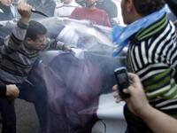 Supporters of the Future Movement rip a poster of Lebanese MP Najib Mikati.
